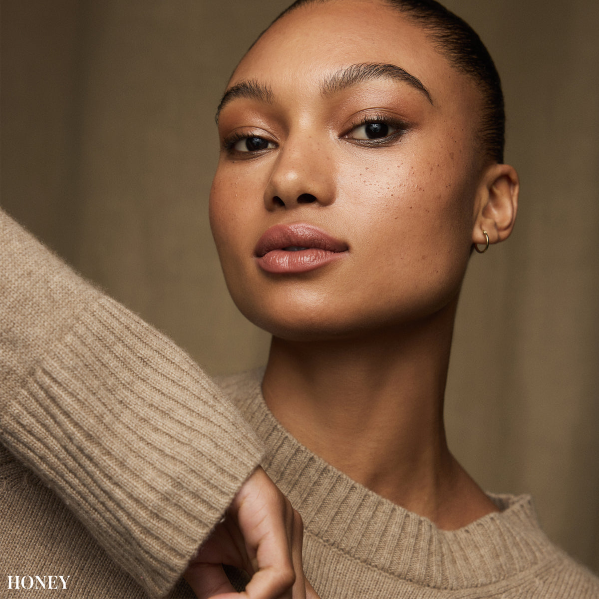 Model wearing RMS Beauty SunCoverup Super Tint SPF 50 in Honey, a medium warm honey shade