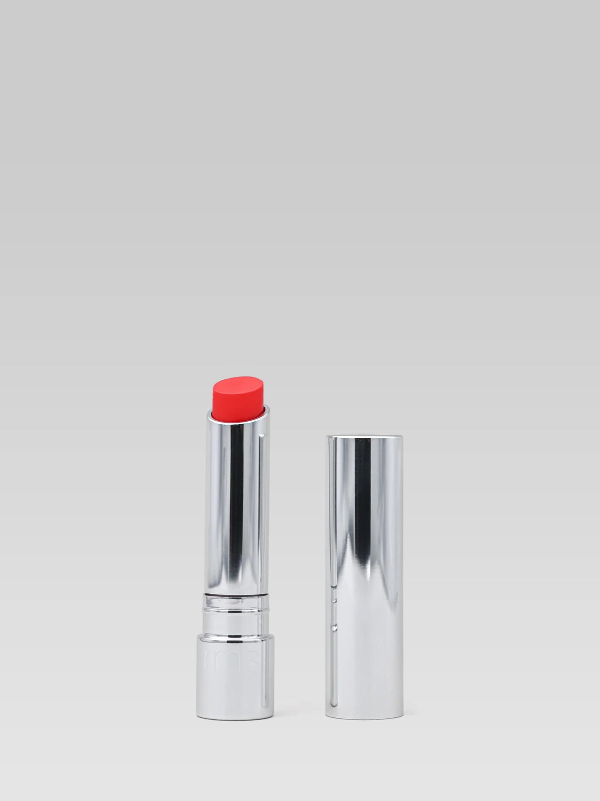 RMS Beauty Tinted Daily Lip Balm in Crimson Lane, vibrant red tinted lip balm in silver packaging with cap displayed beside the open tube