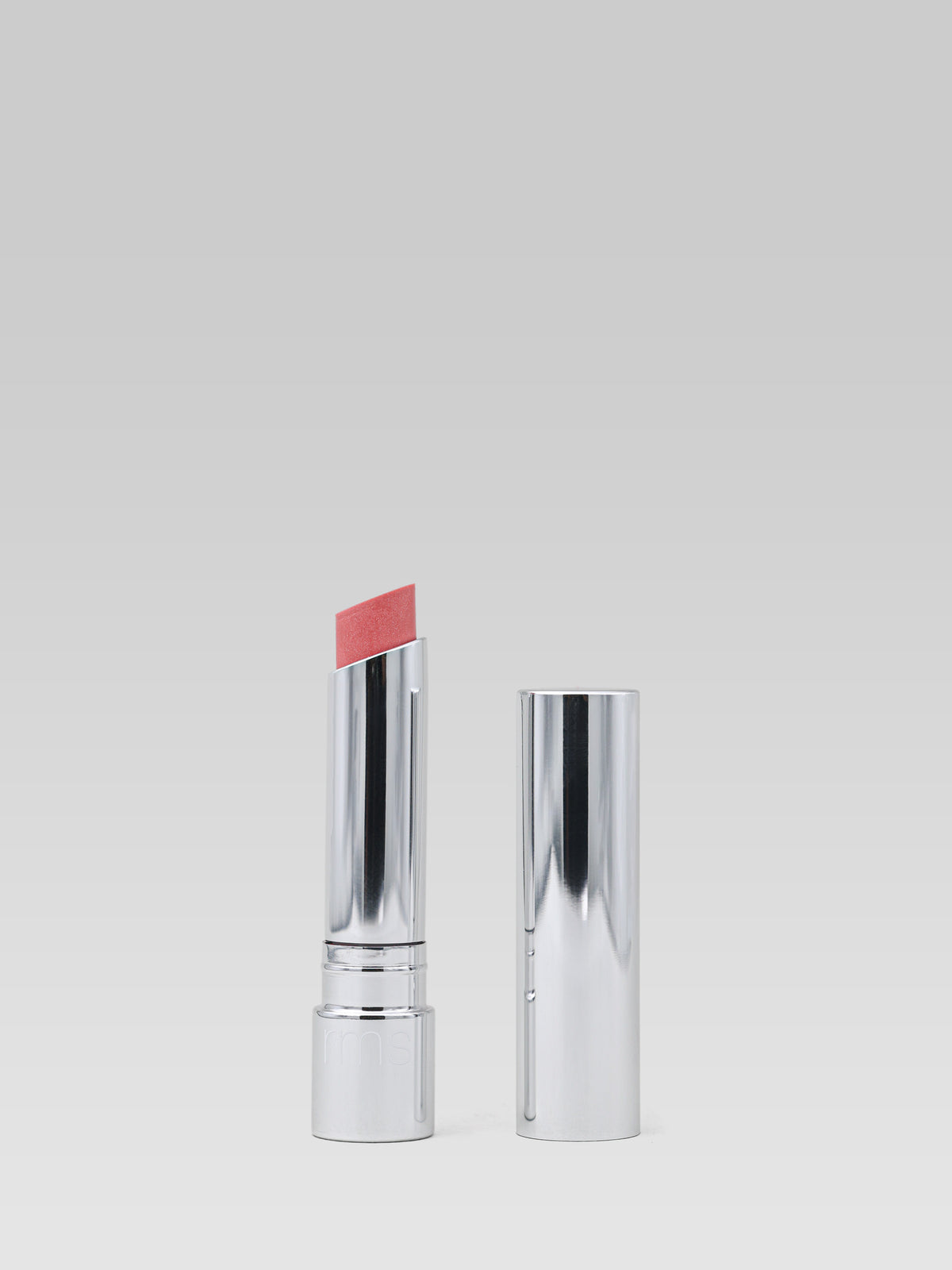 RMS Beauty Tinted Daily Lip Balm in Passion Lane, a pink-tinted lip balm in a silver tube shown open and closed on a light background