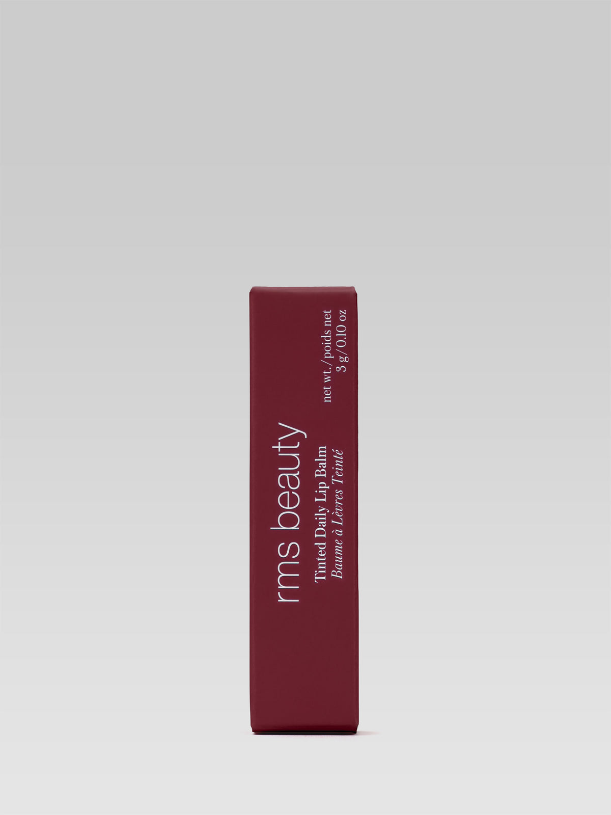 RMS Beauty Tinted Daily Lip Balm in Twilight Lane packaging, deep burgundy-red rectangular carton with white lettering on a light grey background