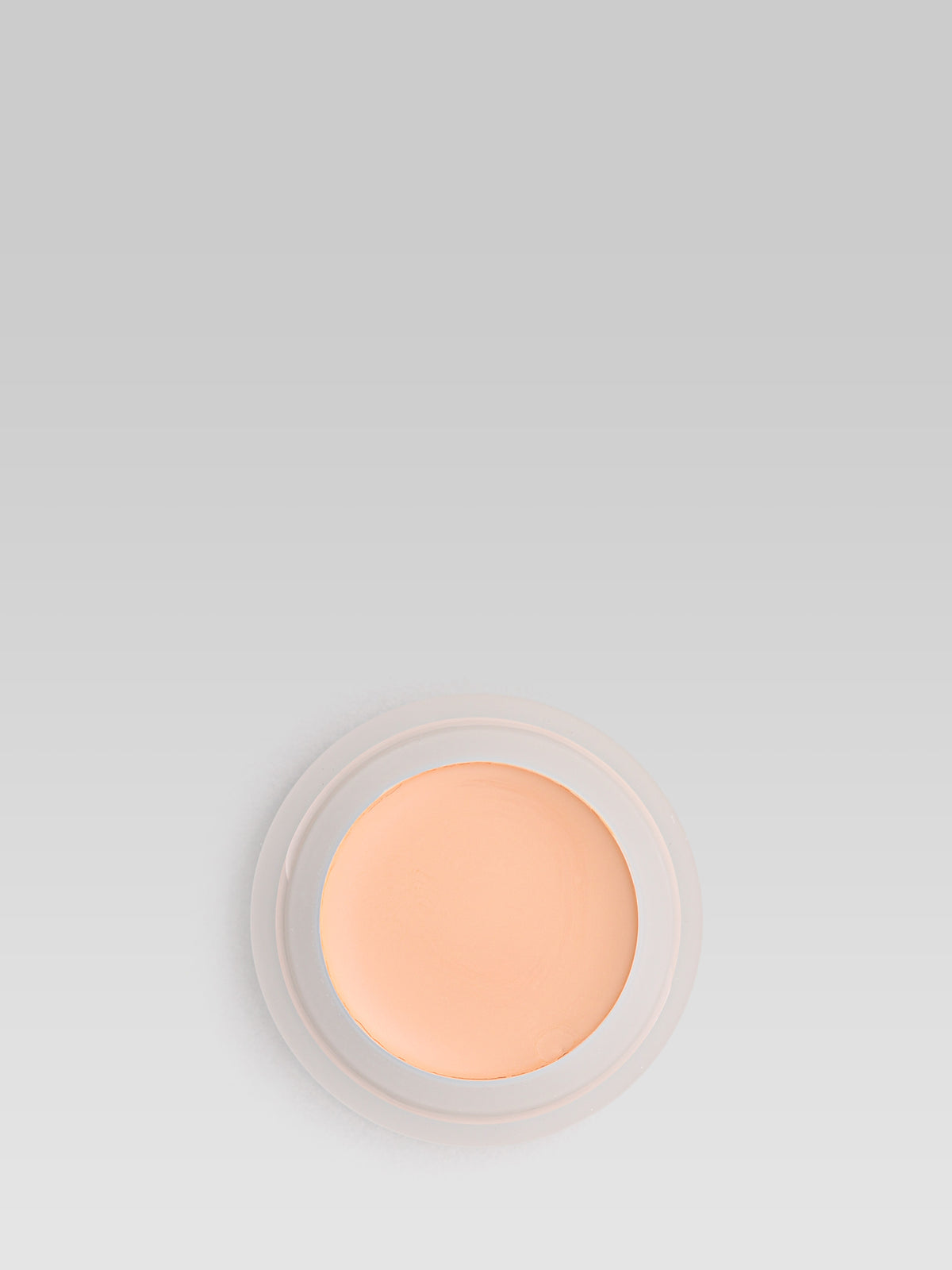 RMS Beauty UnCoverup Concealer in shade 11.5, shown in an open round pot with a warm peach-beige cream formula against a light grey background