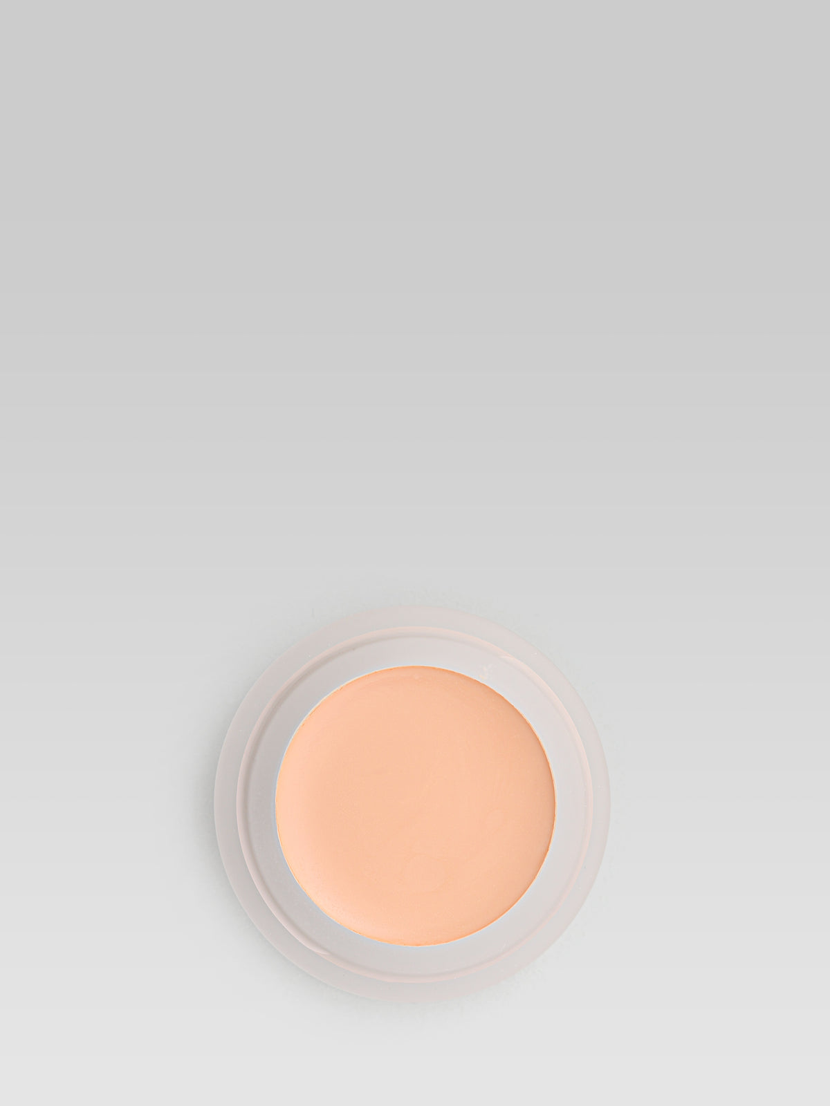 RMS Beauty UnCoverup Concealer in shade 11, shown in an open round pot with a warm peach-toned cream formula against a light grey background.