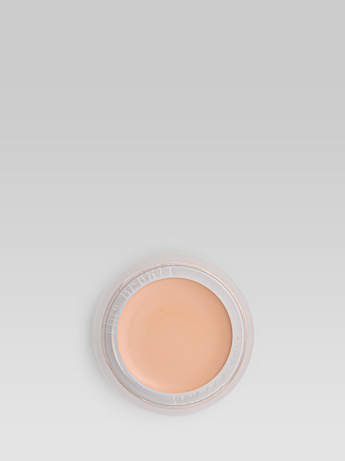 RMS Beauty UnCoverup Concealer in shade 22.5, shown in an open round pot with a warm peach-beige cream concealer against a light grey background