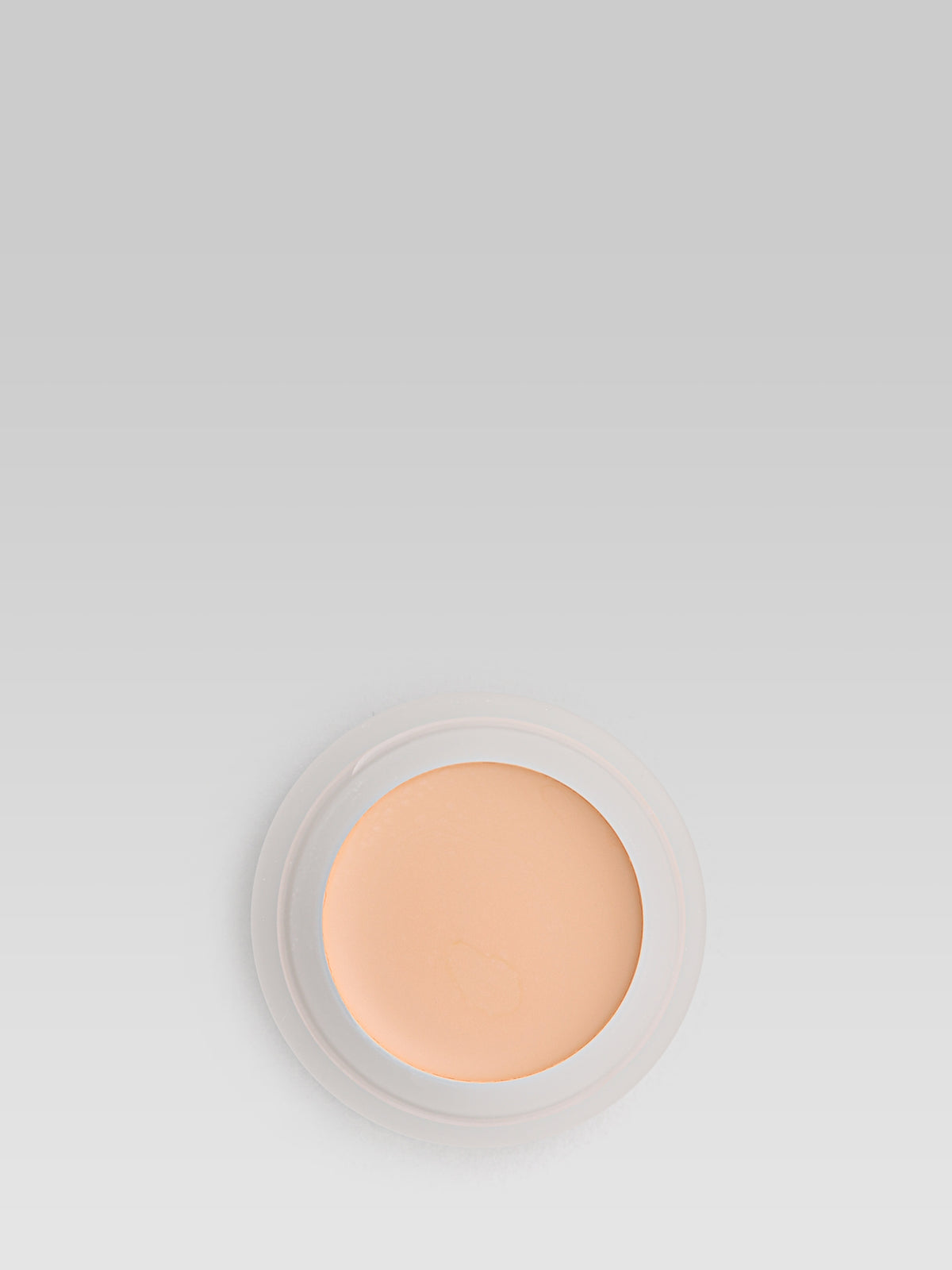RMS Beauty UnCoverup Concealer in shade 22, shown in an open round pot with a warm medium-deep peach-beige cream formula against a light grey background