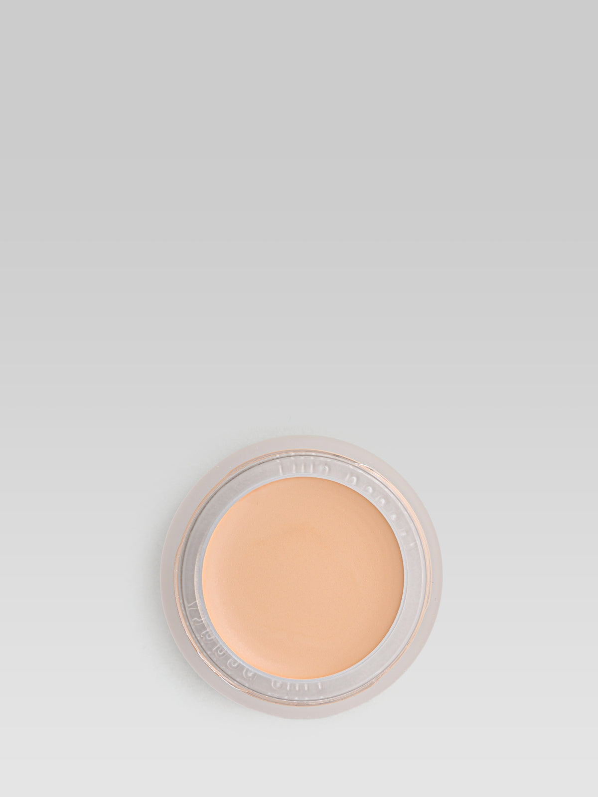 RMS Beauty UnCoverup Concealer in shade 33, shown in an open round pot with a warm peach-toned cream concealer against a light grey background