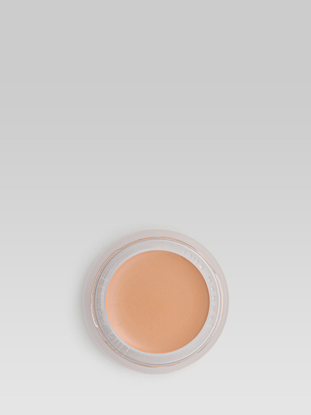 RMS Beauty UnCoverup Concealer in shade 44, shown in an open round pot with a warm medium-deep caramel-beige cream concealer against a light grey background