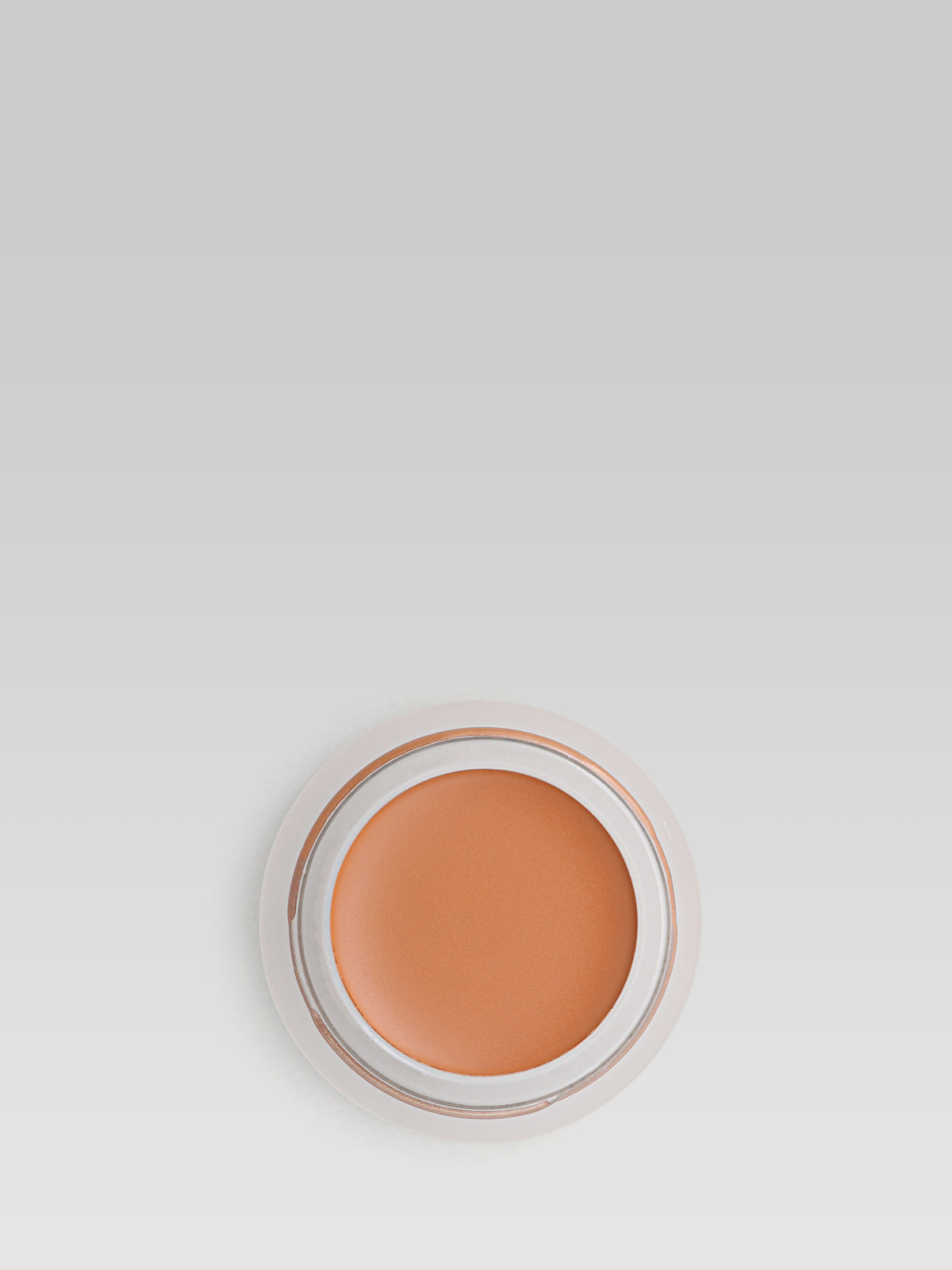 RMS Beauty UnCoverup Concealer in shade 66, shown in an open round pot with a warm medium-deep orange-brown cream concealer against a light grey background