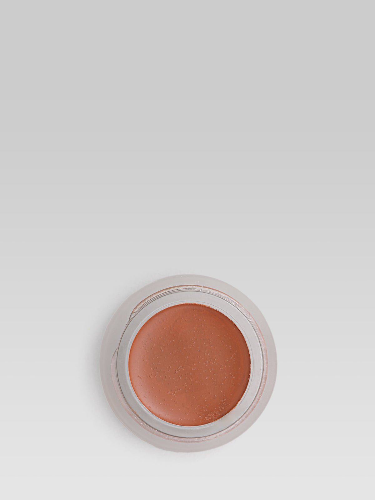 RMS Beauty UnCoverup Concealer in shade 88, shown in an open round pot with a warm deep terracotta-brown cream concealer against a light grey background