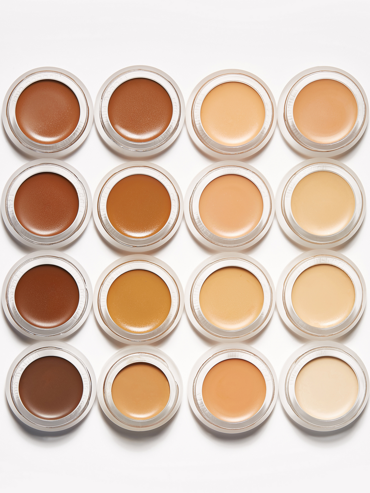 RMS Beauty UnCoverup Concealer shades displayed in open pots, showing a range of creamy concealer colours from light ivory and peach to warm tan and deep brown