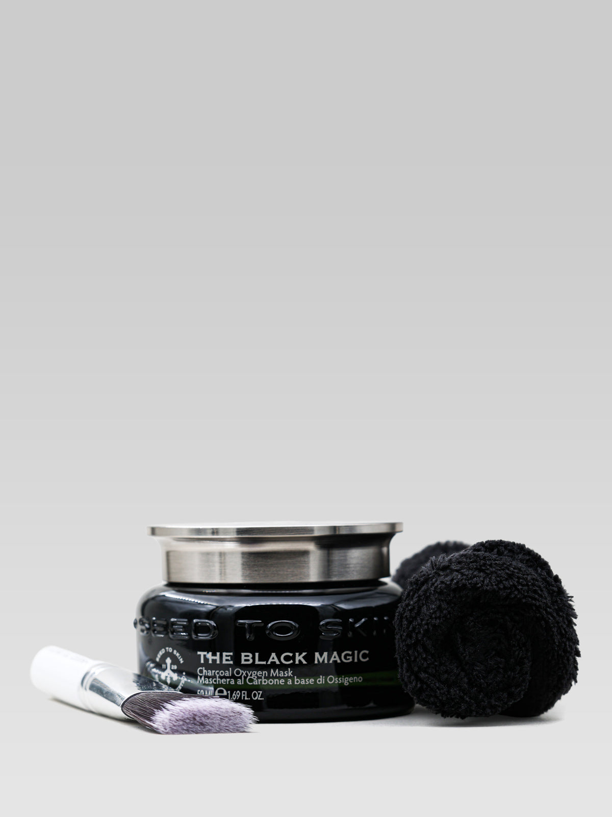 Seed to Skin The Black Magic detoxifying oxygen mask with black towel and application brush