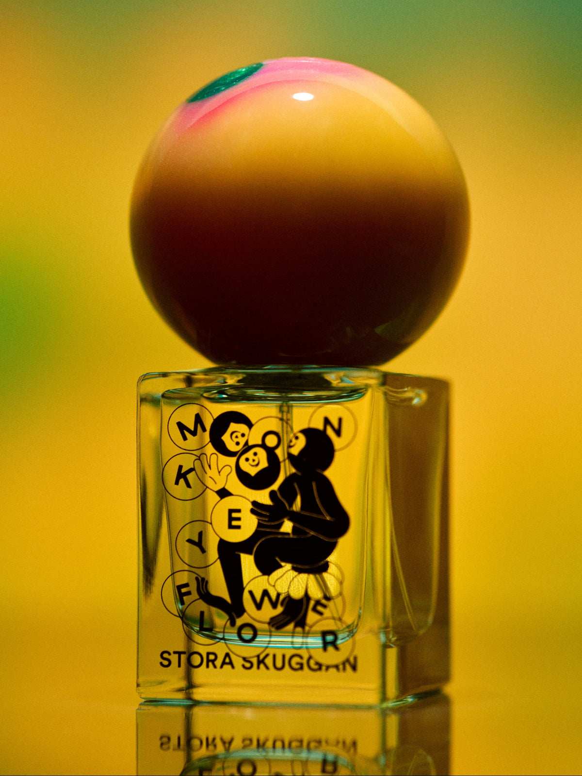 Stora Skuggan Moonflower perfume bottle with apple-shaped cap in artistic yellow and green setting