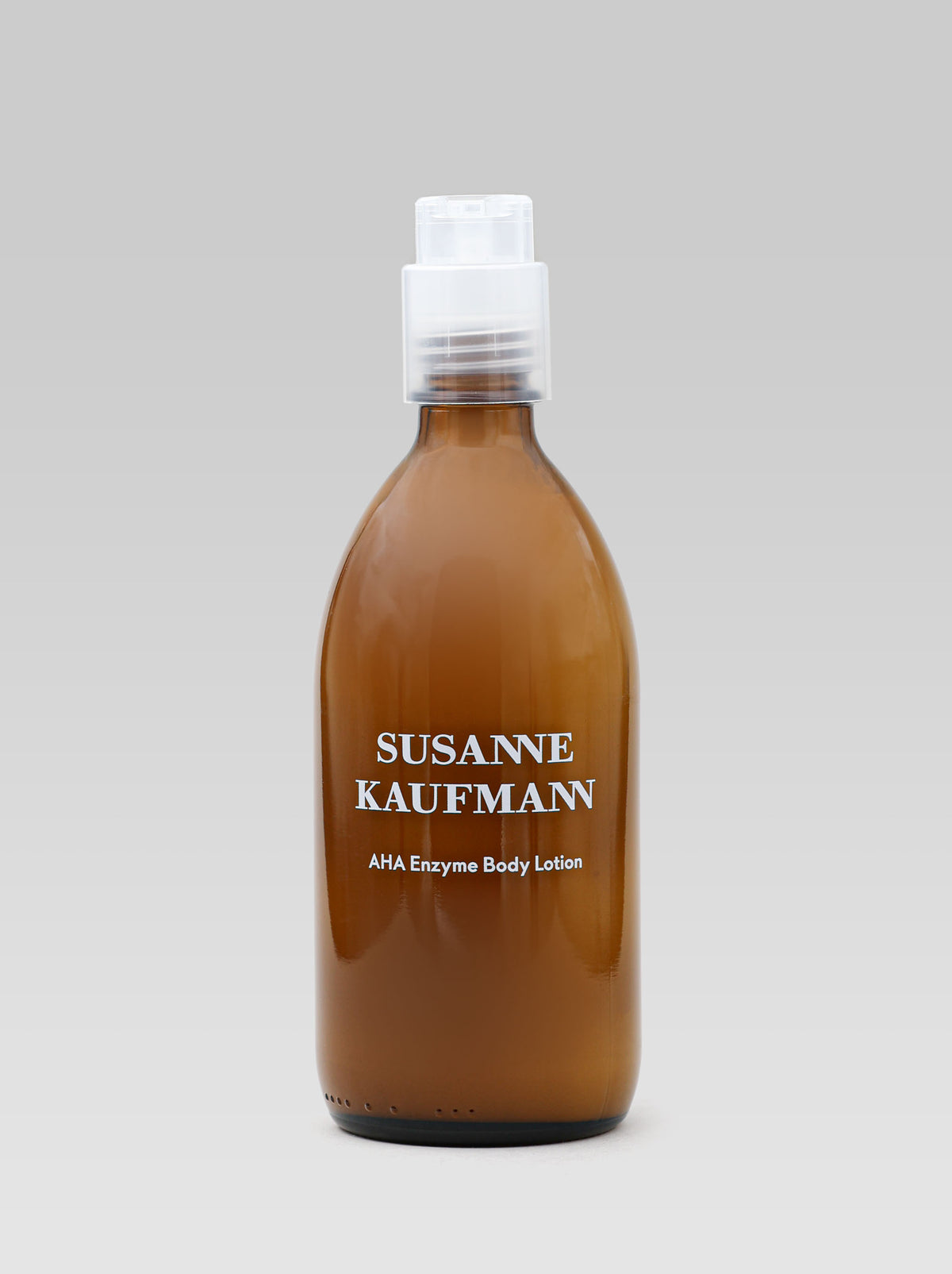 Susanne Kaufmann AHA Enzyme Body Lotion 250 ml in an amber bottle with a pump dispenser