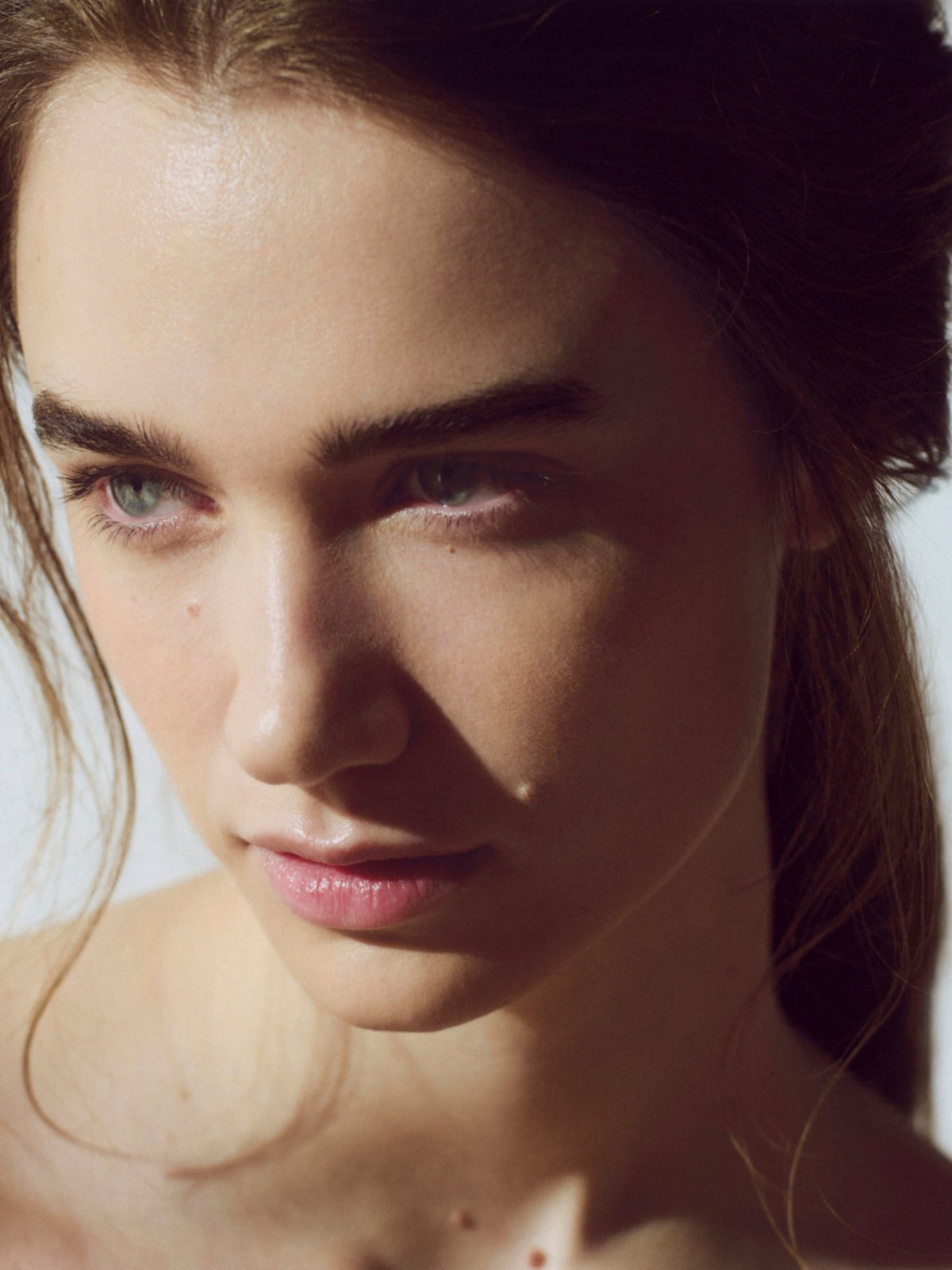 Close-up portrait of a woman with naturally radiant-looking skin