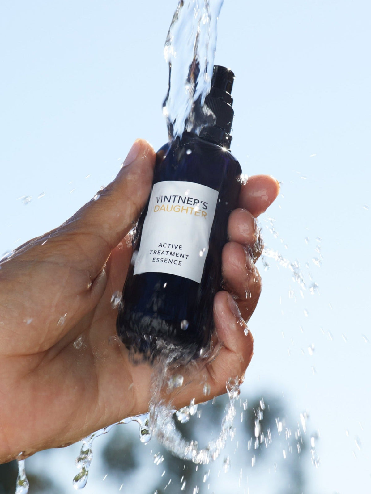 Vintner's Daughter Active Treatment Essence bottle under running water