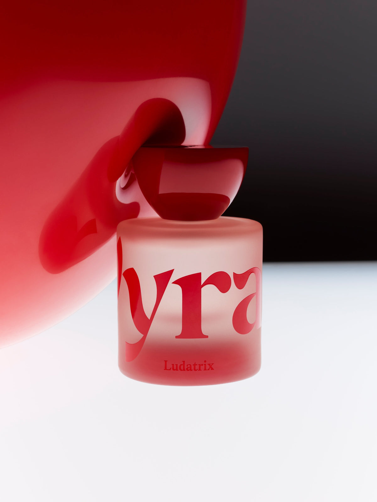 VYRAO Ludatrix Eau de Parfum bottle in red and white light