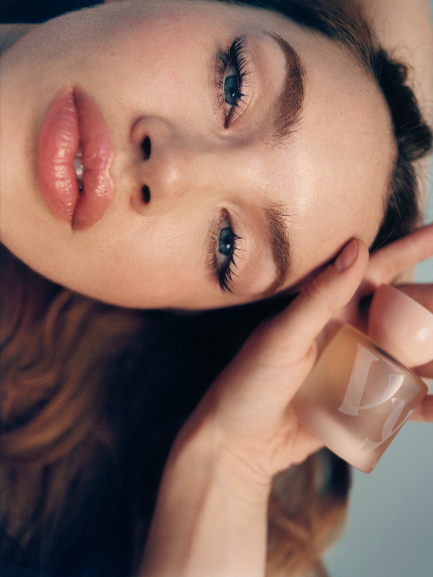 VYRAO Ludexa Eau de Parfum bottle held by a woman in a close-up portrait