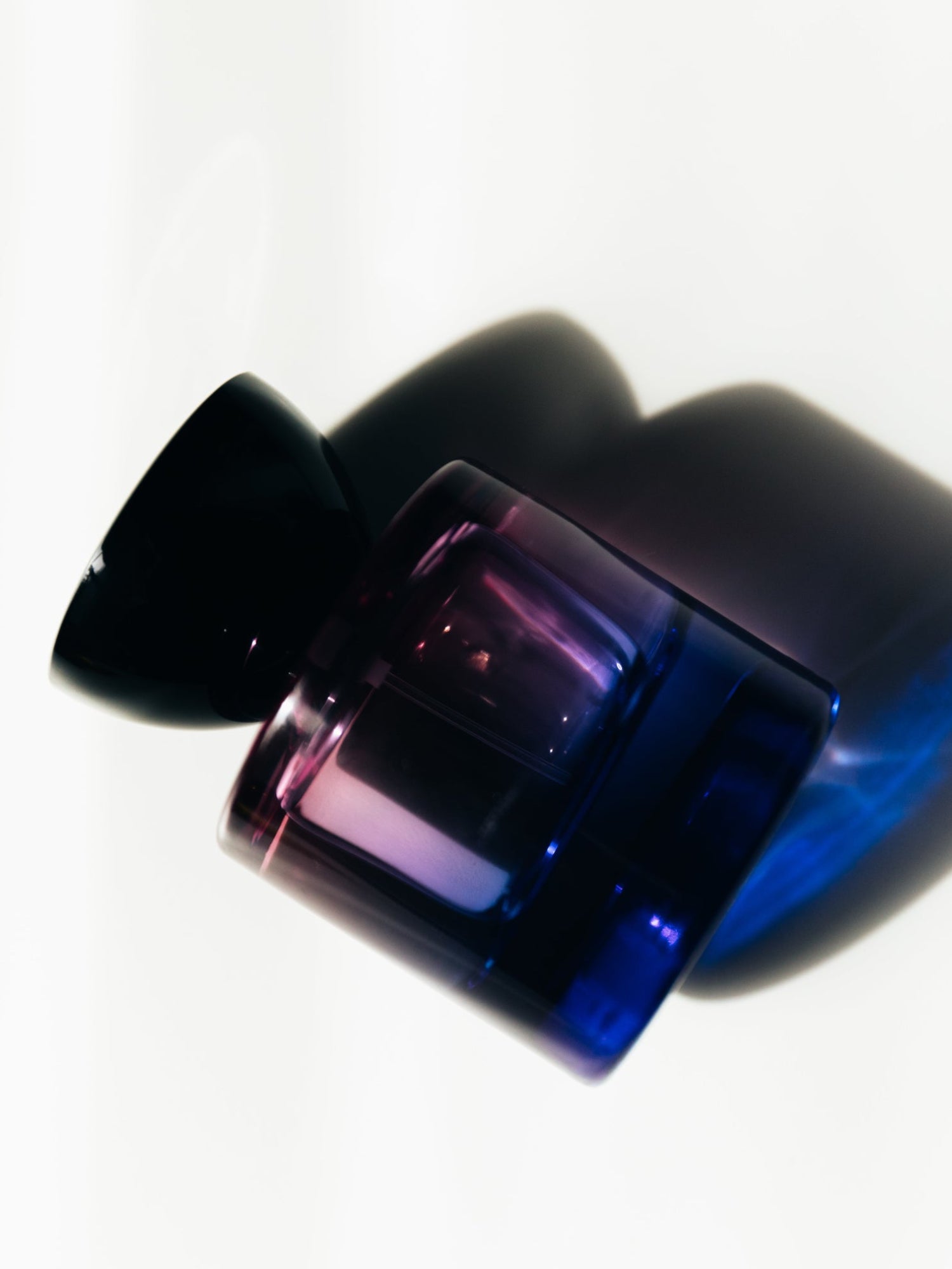 Vyrao Witchy Woo Eau de Parfum bottle in blue and purple light