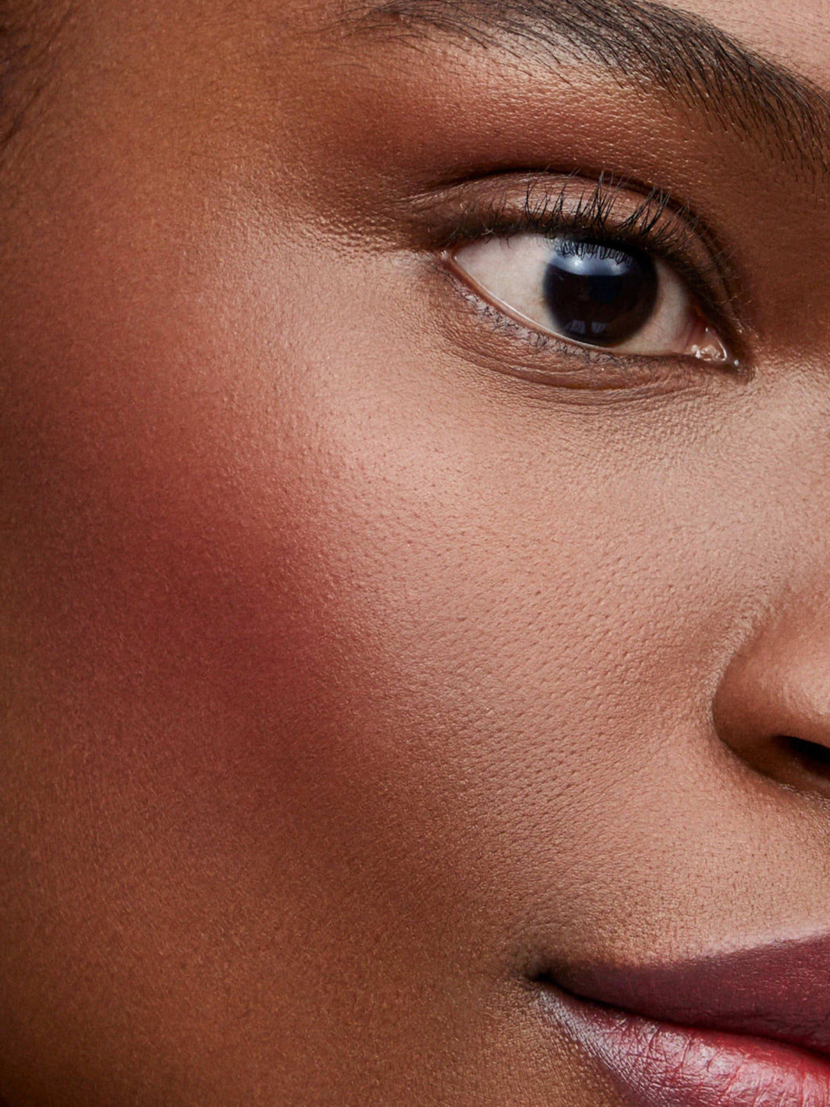 Westman Atelier Baby Cheeks Blush Stick in Bichette on cheek close-up