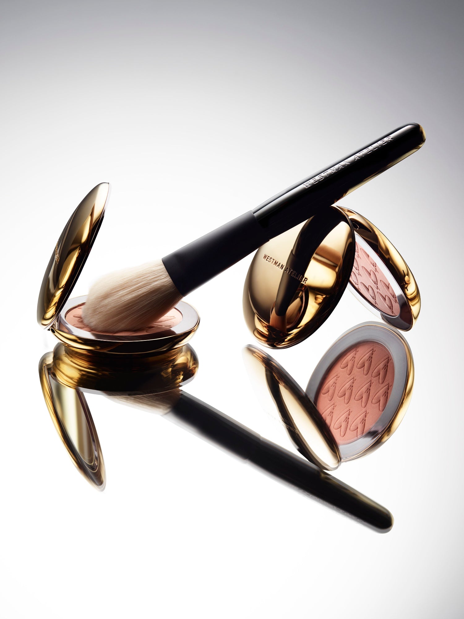 Westman Atelier Beauty Butter Bronzer in Soleil Riche and Peau de Soleil with makeup brush