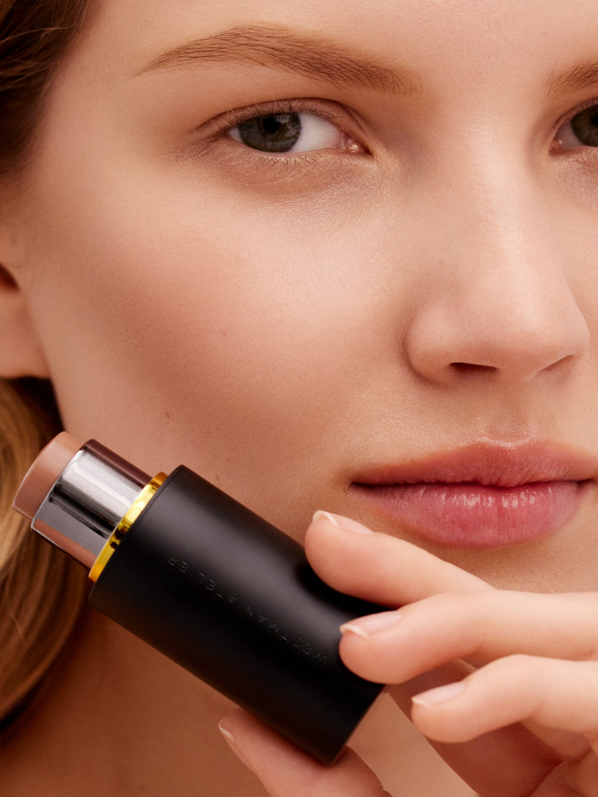 Model wearing WESTMAN ATELIER Face Trace Contour Stick in Biscuit