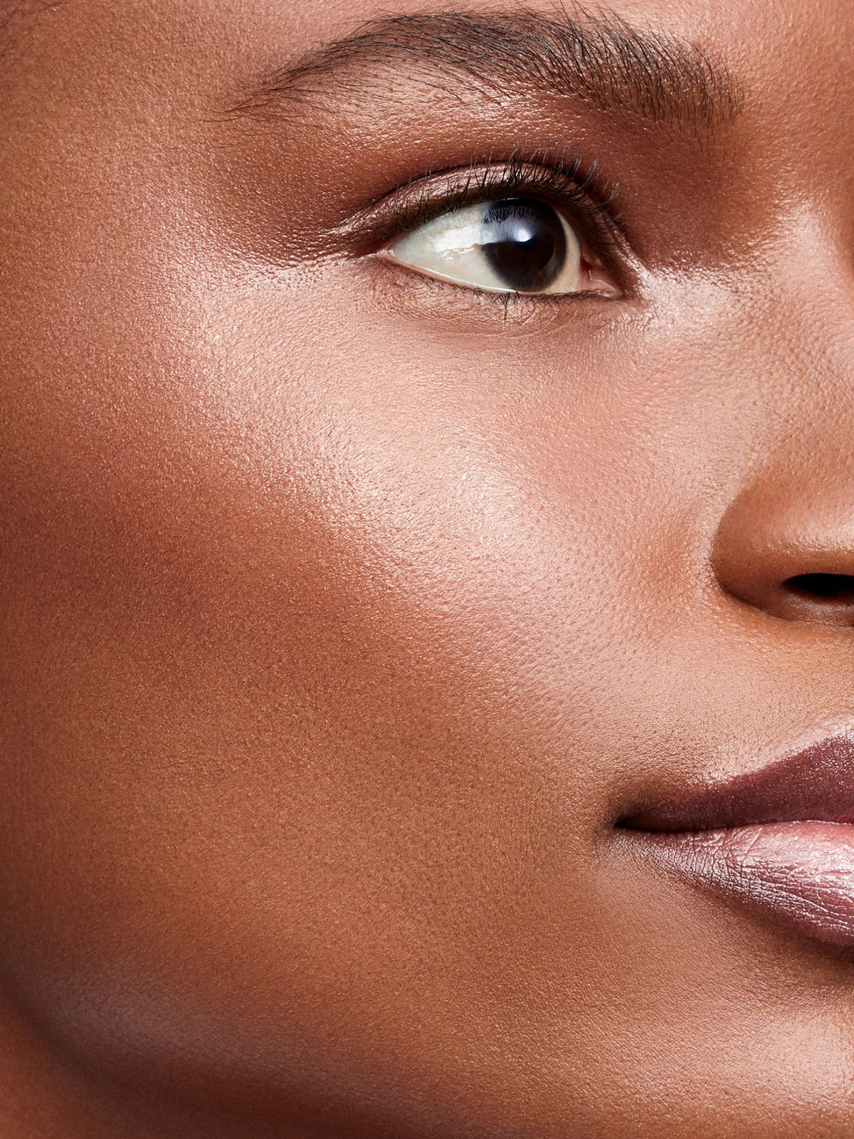 Westman Atelier Lit Up Highlight Stick in Nectar on model