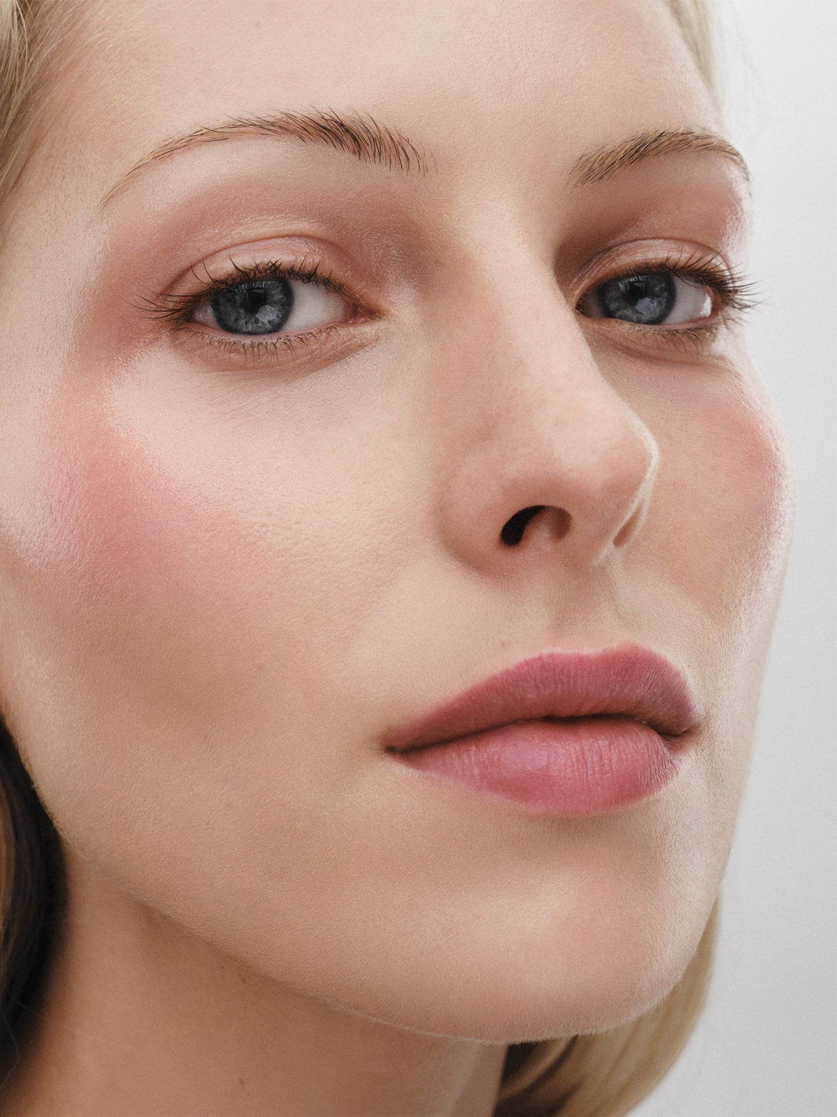Westman Atelier Lit Up Highlight Stick in Petal on model